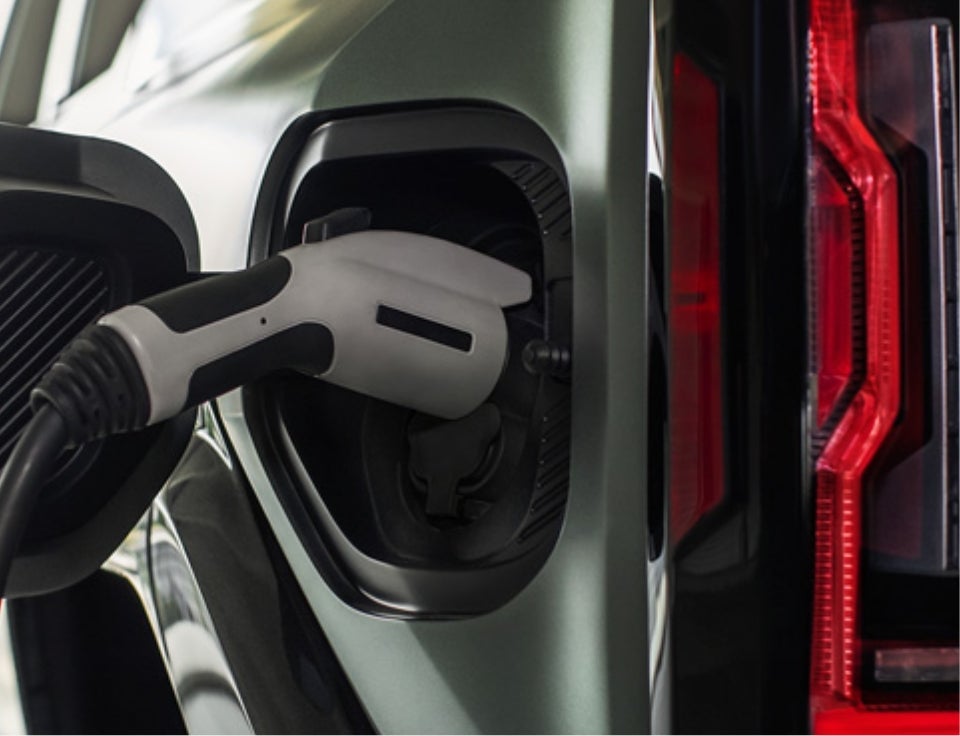 Close up of charging port with charger plugged in on a GMC Hummer EV SUV - Vince's GM Center - GMC in BURLINGTON CO