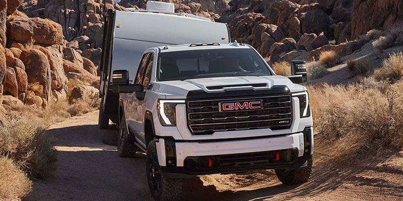 A white 2025 GMC Sierra 2500 HD in mountain area