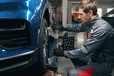 Car mechanic performing Alignment